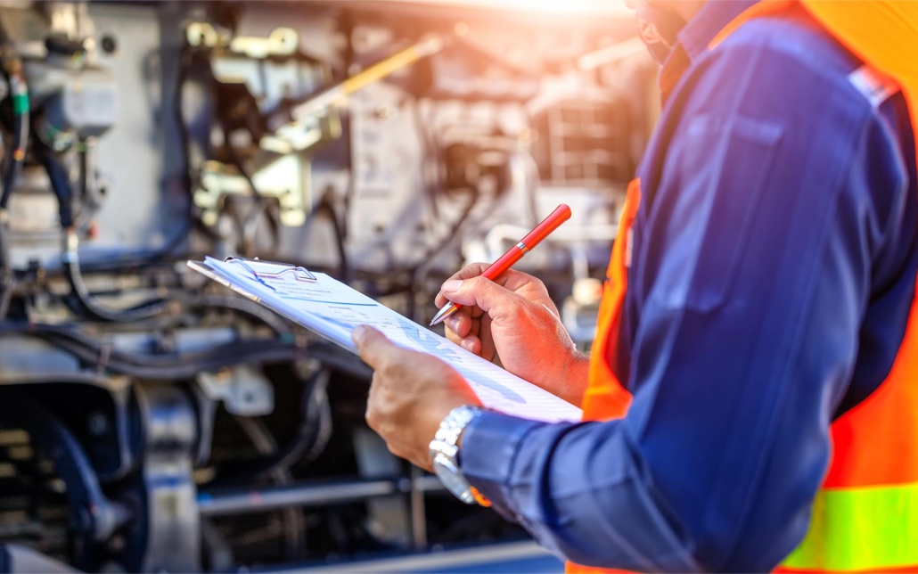 Worker looking at maintenance checklist on clipboard