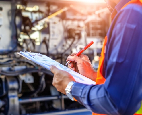 Worker looking at maintenance checklist on clipboard