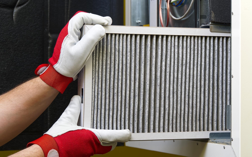 Worker replacing HVAC filter