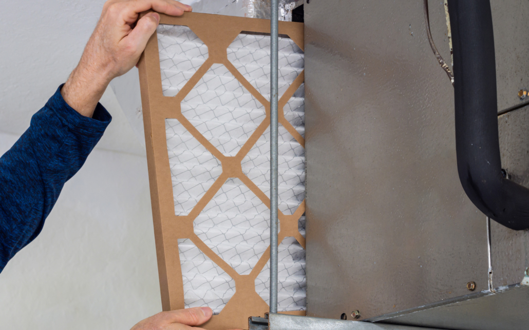 HVAC service technician changing dirty indoor air filter