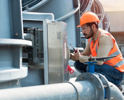 Worker inspecting HVAC system