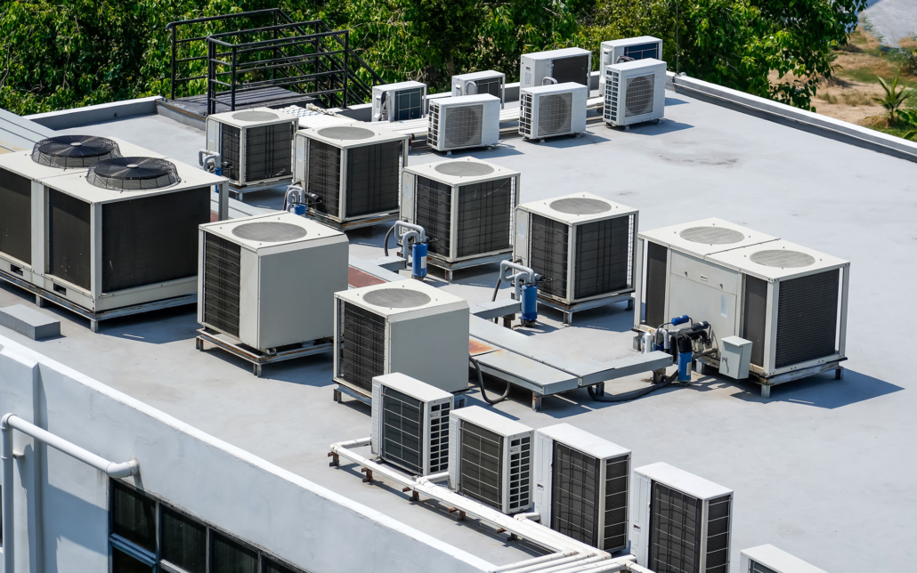 The external units of the commercial air conditioning and ventilation systems are installed on the roof of an industrial building