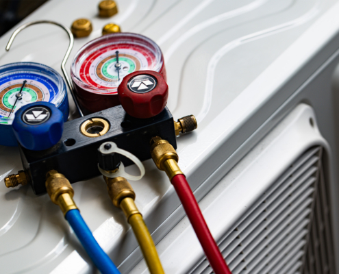 Refrigerant Manifold Gauges Connected to AC Unit