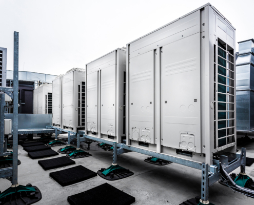 Series of gradually receding air conditioning units on roof_