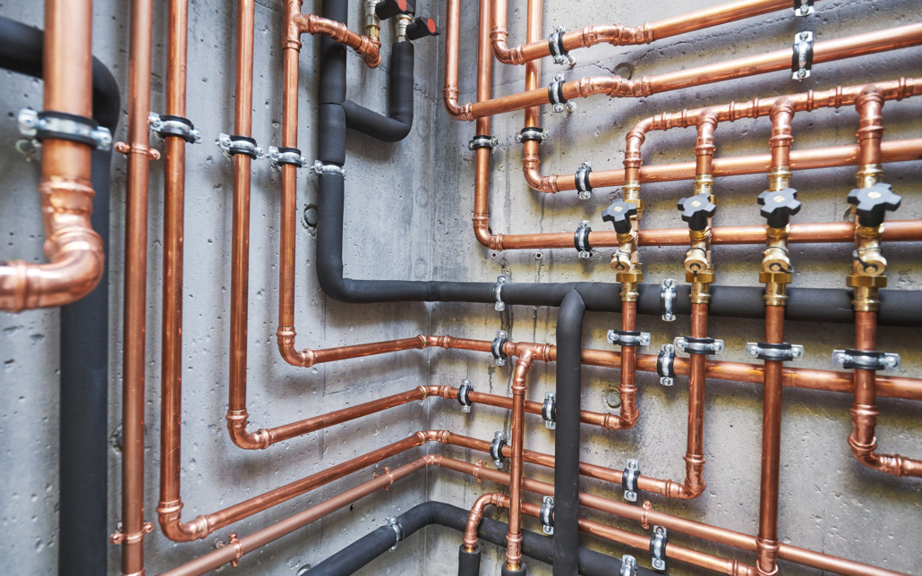 Industrial plumbing pipes along wall