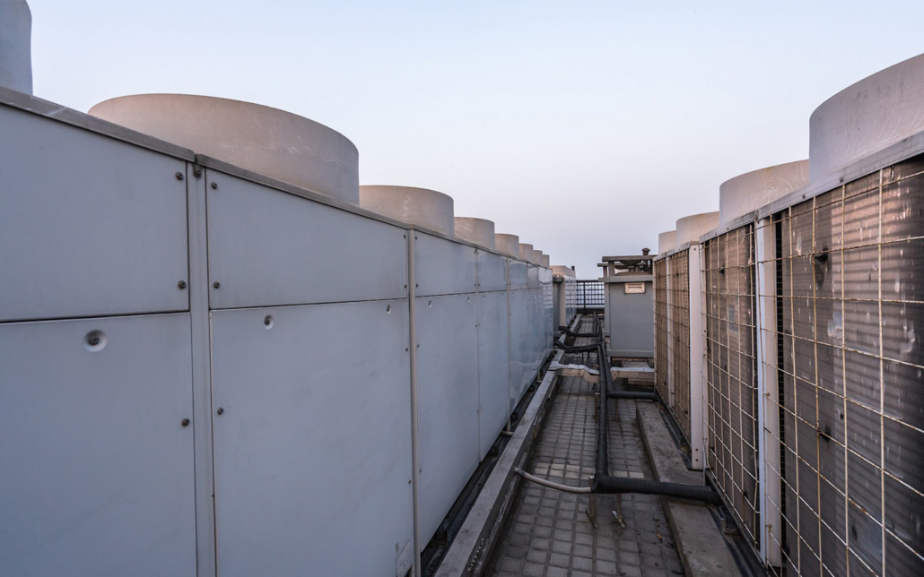 Large HVAC units on top of roof at dawn