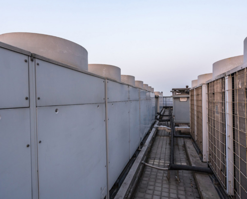 Large HVAC units on top of roof at dawn