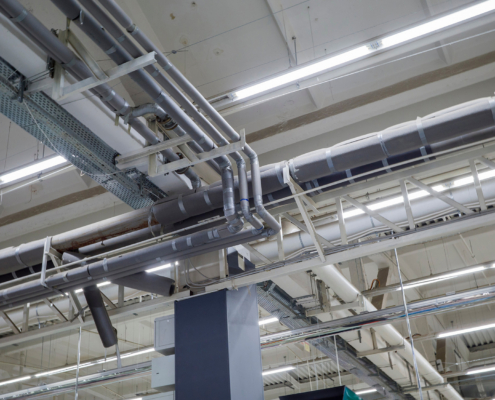 HVAC and plumbing on ceiling of industrial building